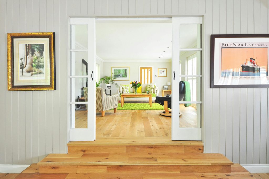 A bright and inviting living room with modern furnishings, a cozy seating area, and natural light streaming through large windows.