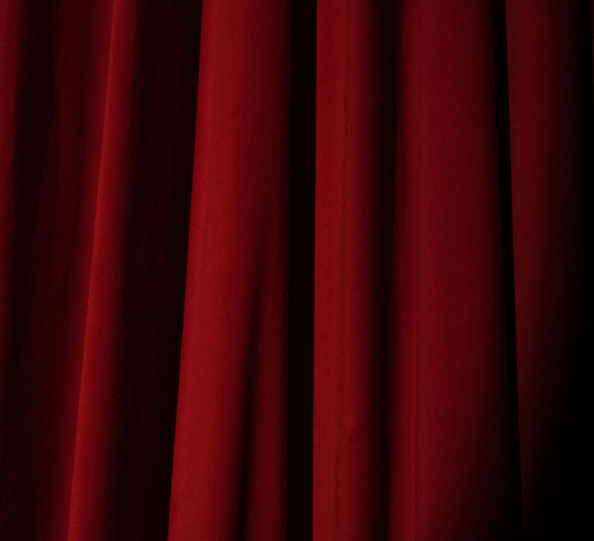Rich red theater curtains symbolizing upcoming events and entertainment.